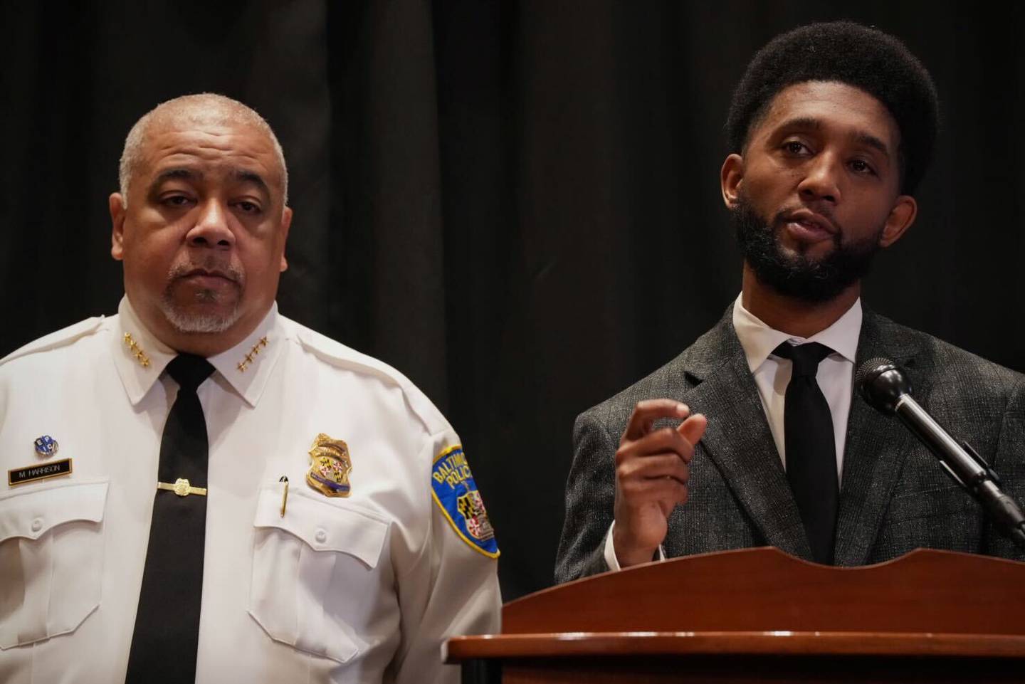 Baltimore Mayor Brandon Scott, right, speaks during a press conference at Baltimore City Hall on Wednesday, Dec. 21. To his left is Police Commissioner Michael Harrison.