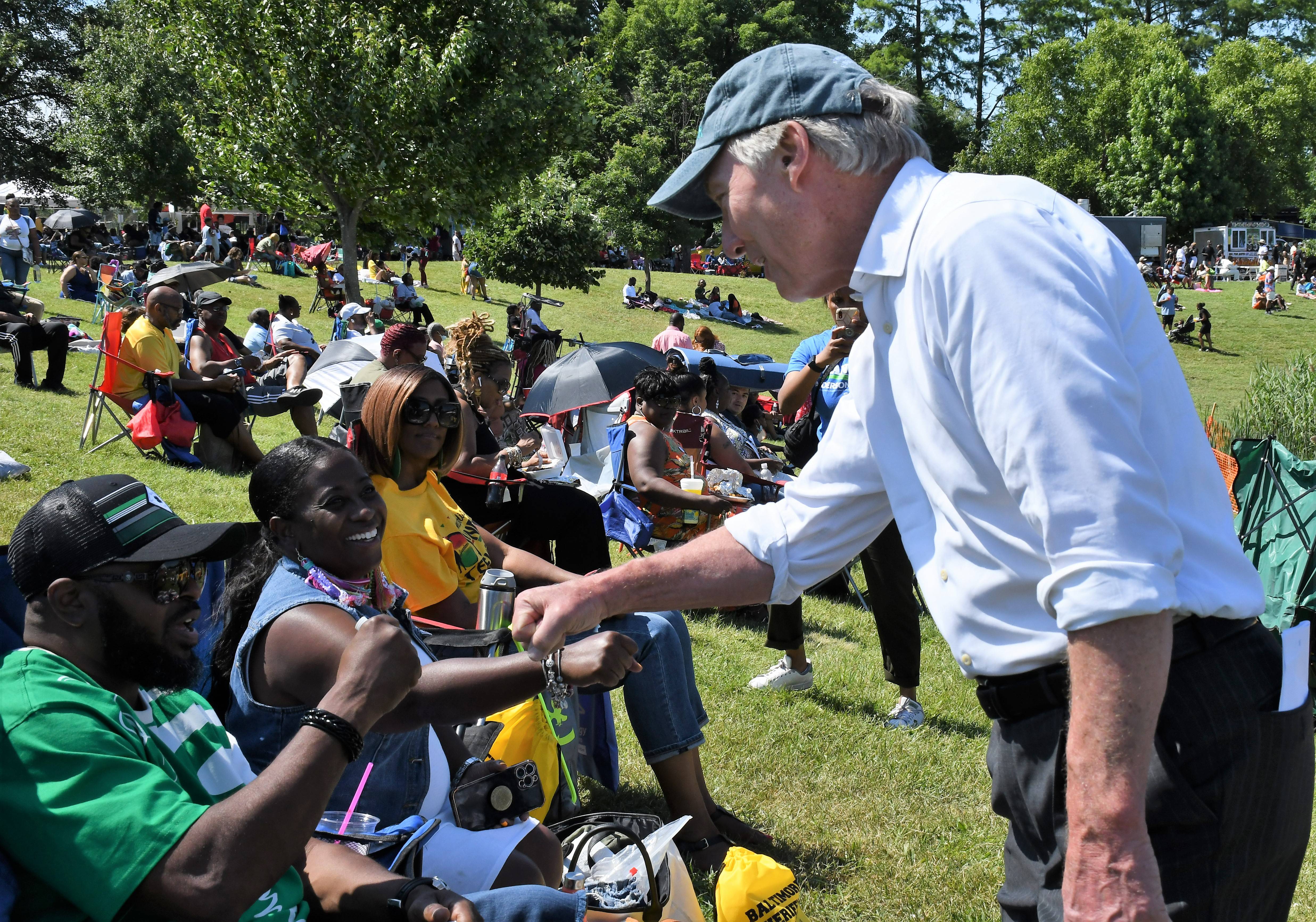 Peter Franchot, the state comptroller who is running for governor as a Democrat, fist-bumps with LaShonnah and Preston Small of Waldorf during the AFRAM festival at Druid Hill Park on Sunday, June 19, 2022.