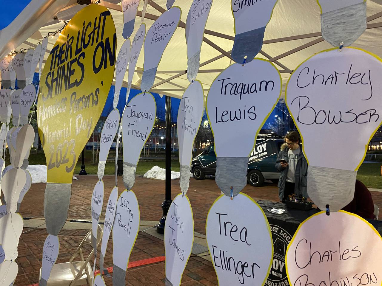 The names of people who had experienced homelessness and died in Baltimore in 2023 were hung up at a vigil at McKeldin Square in the shape of light bulbs, representing each person's light. Dec. 21, 2023.