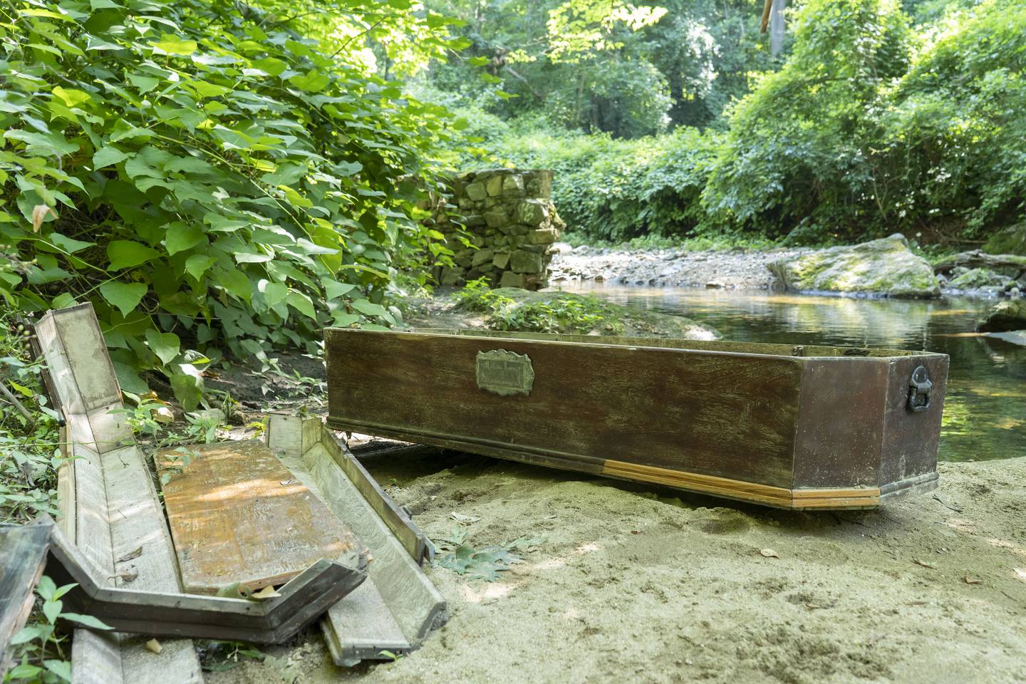 The casket rests next to the stream in Wyman Park.