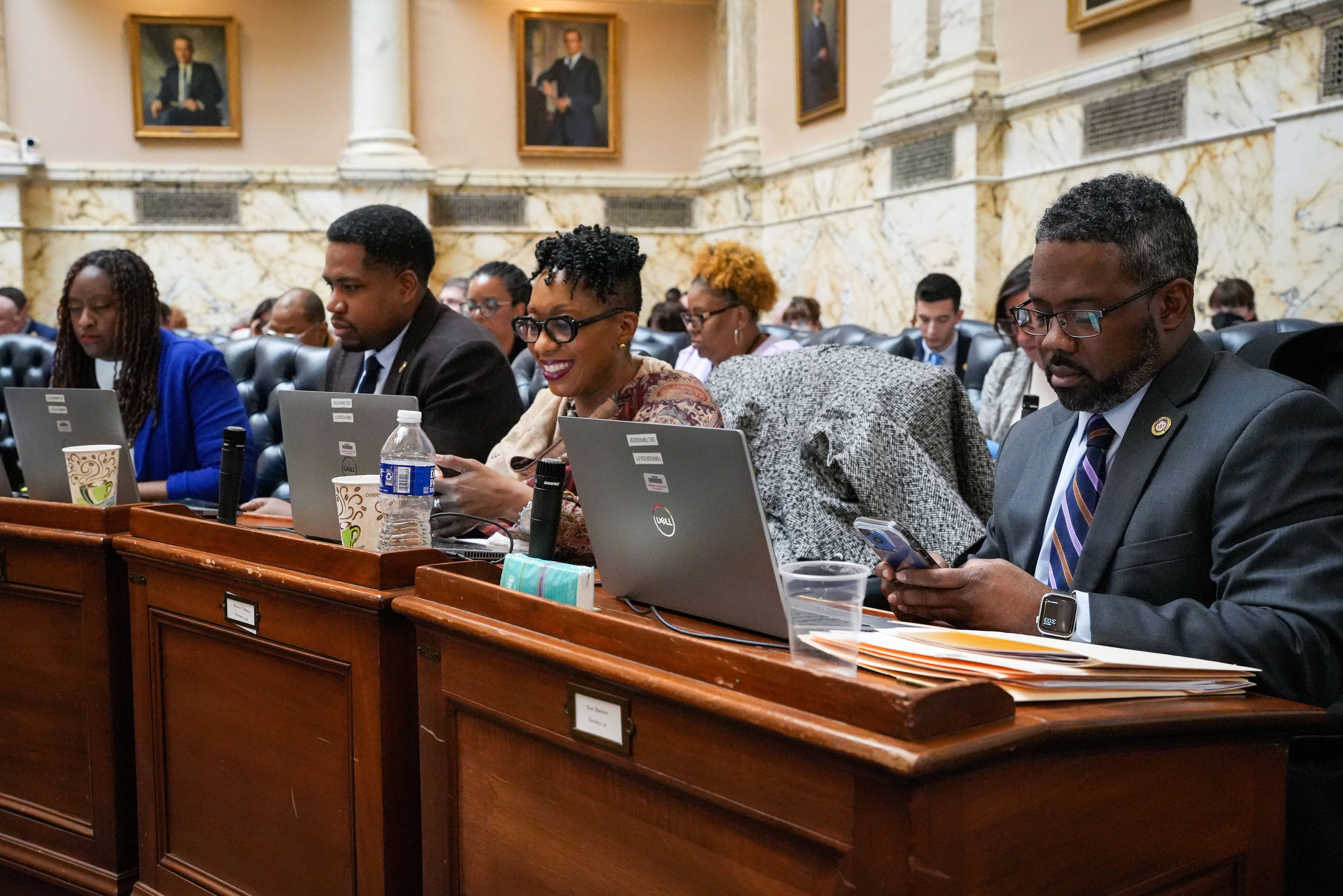 From left: Del. Stephanie Smith, Del. Marlon Amprey, Del. Regina Boyce and Del. Tony Bridges, all representing Baltimore City, listen to floor debate at the Maryland State House on Monday, March 20, also known as Crossover Day in Annapolis. General Assembly session rules require bills to pass one chamber — either the House of Delegates or the state Senate — by the end of the day on Monday, to ensure the other chamber will consider it.