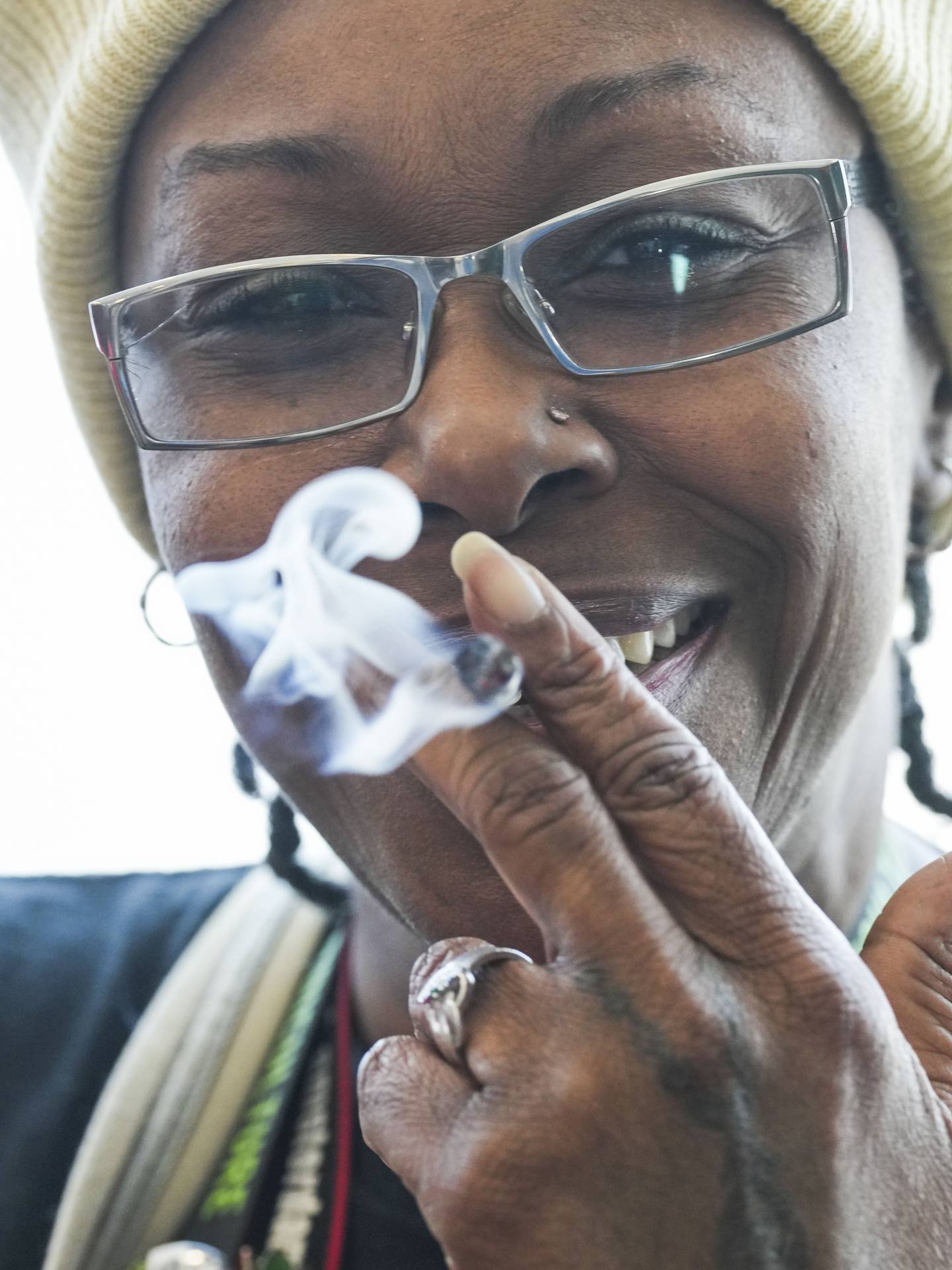 Prudence Watson, 57, smokes a joint at the grand opening of Ceylon House.
