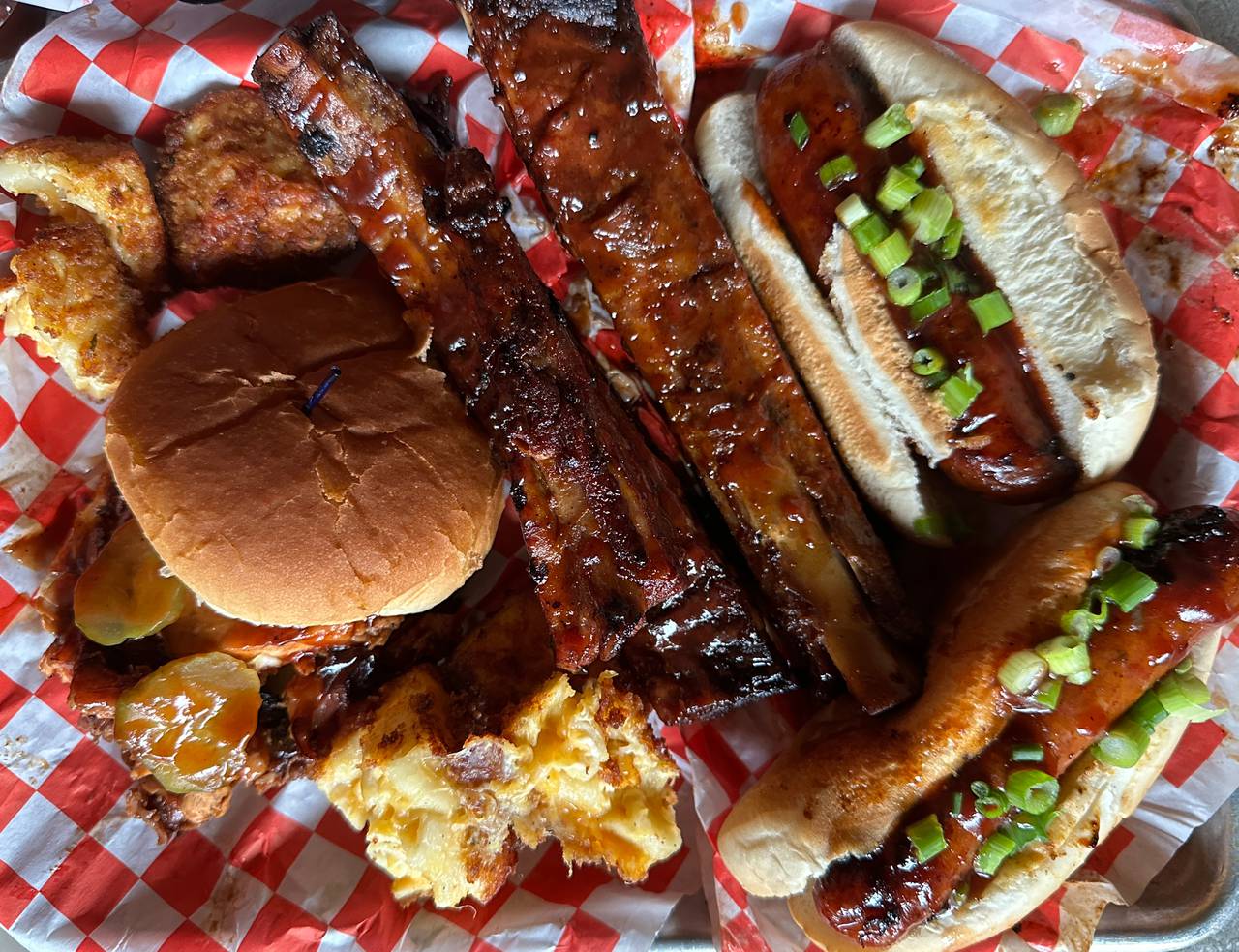 Clockwise from top left: fried mac n cheese balls, ribs, smoked spicy sausage and a drunk chicken sandwich from Southern N Smoked in Cross Street Market.