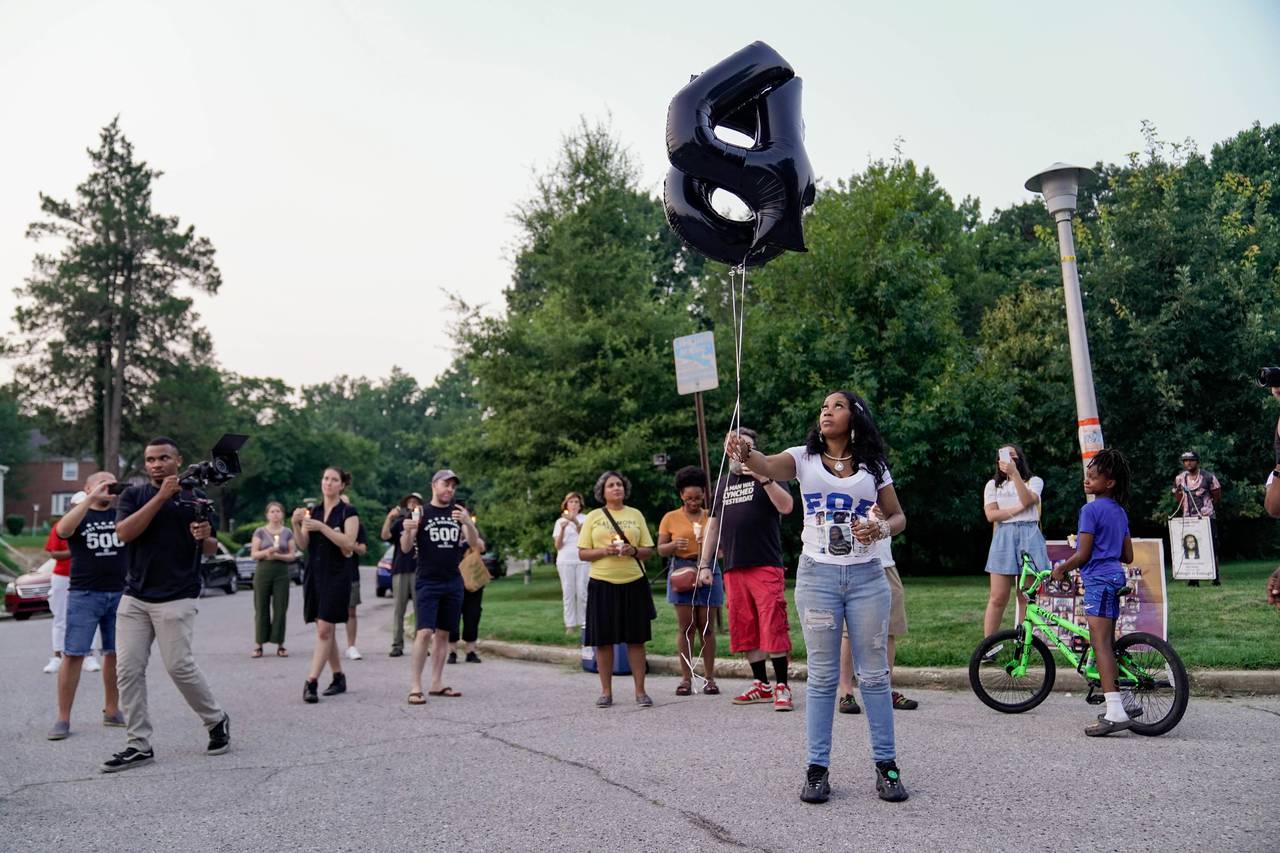 Tawanda Jones holds balloons at the ten year anniversary memorial gathering to honor Tyrone West, who would now be 54, held on the corner of Kitmore Road and Kelway Road on July 18, 2023. West was killed after being pursued by two officers of the Baltimore Police Department after he fled a traffic stop in 2013.