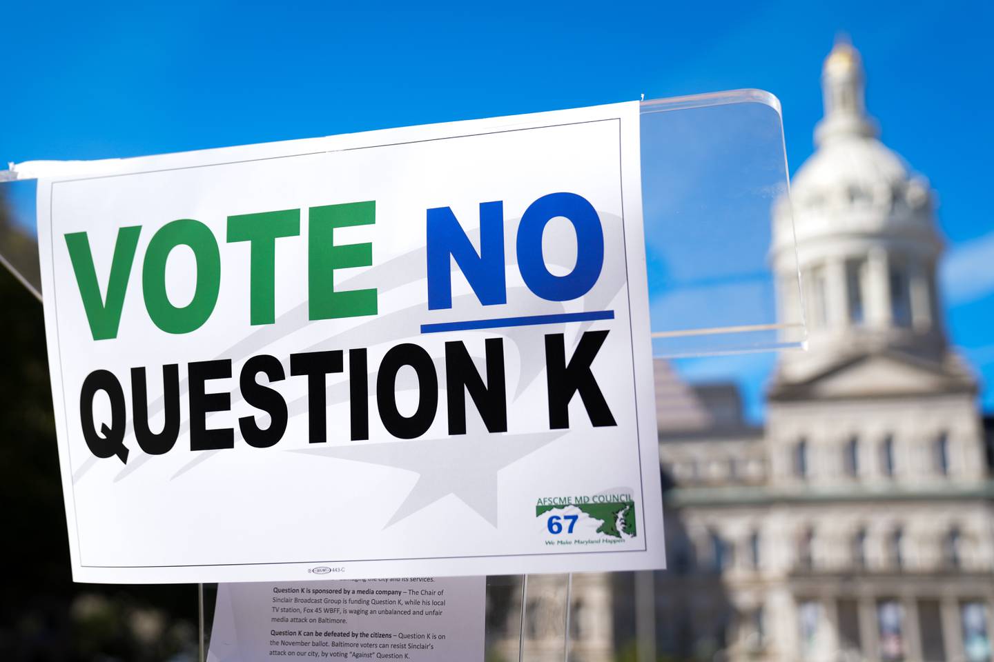 A sign encouraging Baltimore voters to vote no on Question K in the upcoming general election is taped to a lectern during a press conference at War Memorial Plaza on 10/6/22. The question would determine whether or not term limits are imposed on a number of elected positions in the city.