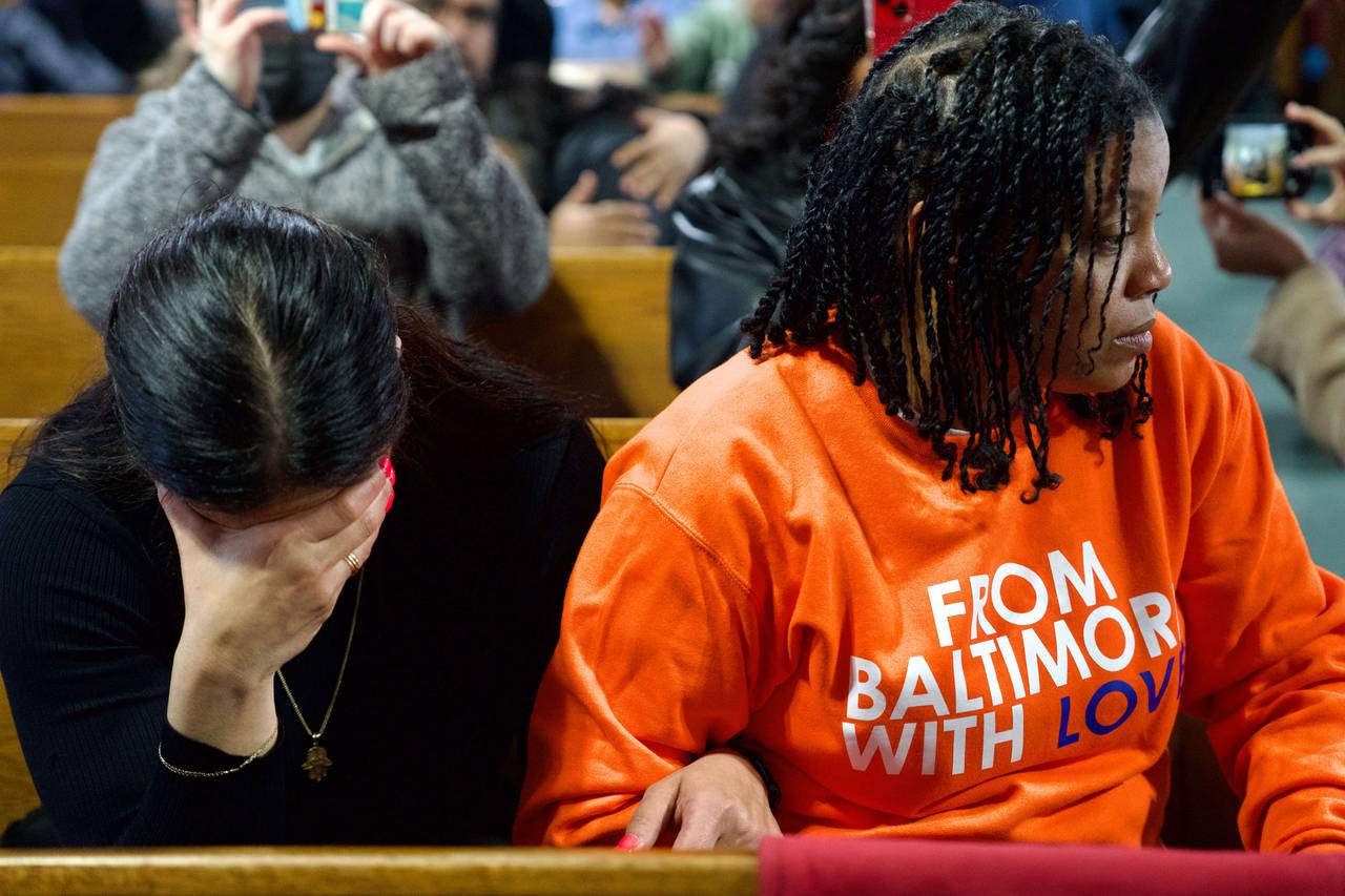 Alejandra Ivanovich, left, takes an emotional moment during prayer while sitting next to her friend Paxton, right. The Turner Station community in Dundalk, right near where the FSK Bridge once stood, participated in a vigil at Mount Olive Baptist Church where people of all denominations were welcome. A handful of elected officials were also in attendance. Prayers and songs lasted about an hour.