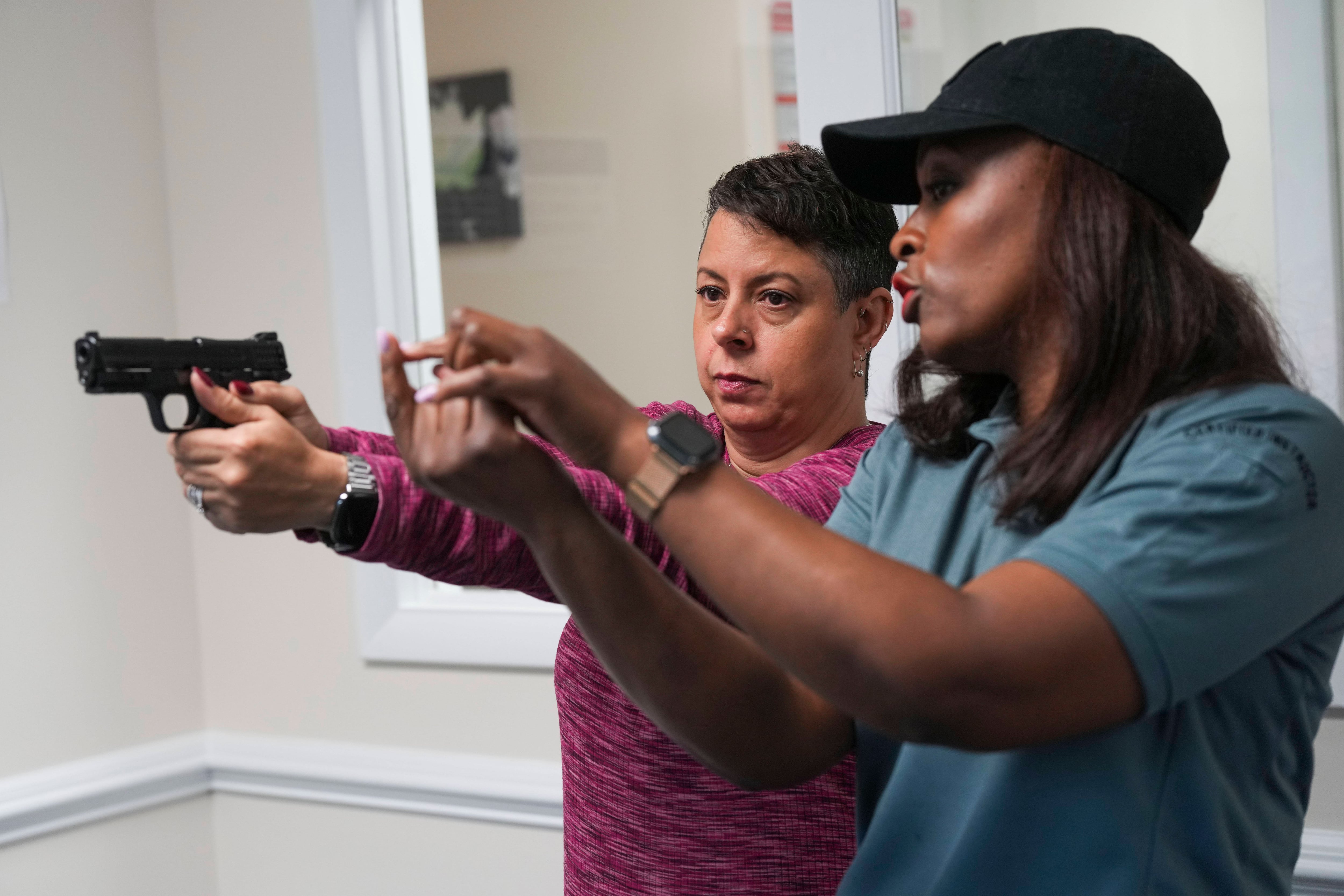 Quiana Roberts, a federal law enforcement agent and firearms instuctor, teaches students how to be safe and responsible gun owners during a class on May 8, 2023.
