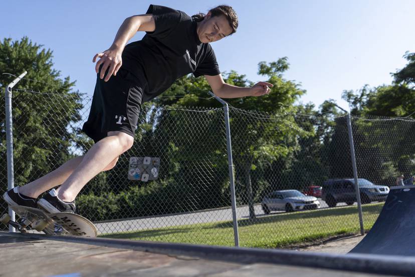 Jacob Gerth skates back and forth on a mini-half pipe at Sandy Hills Skate Park.