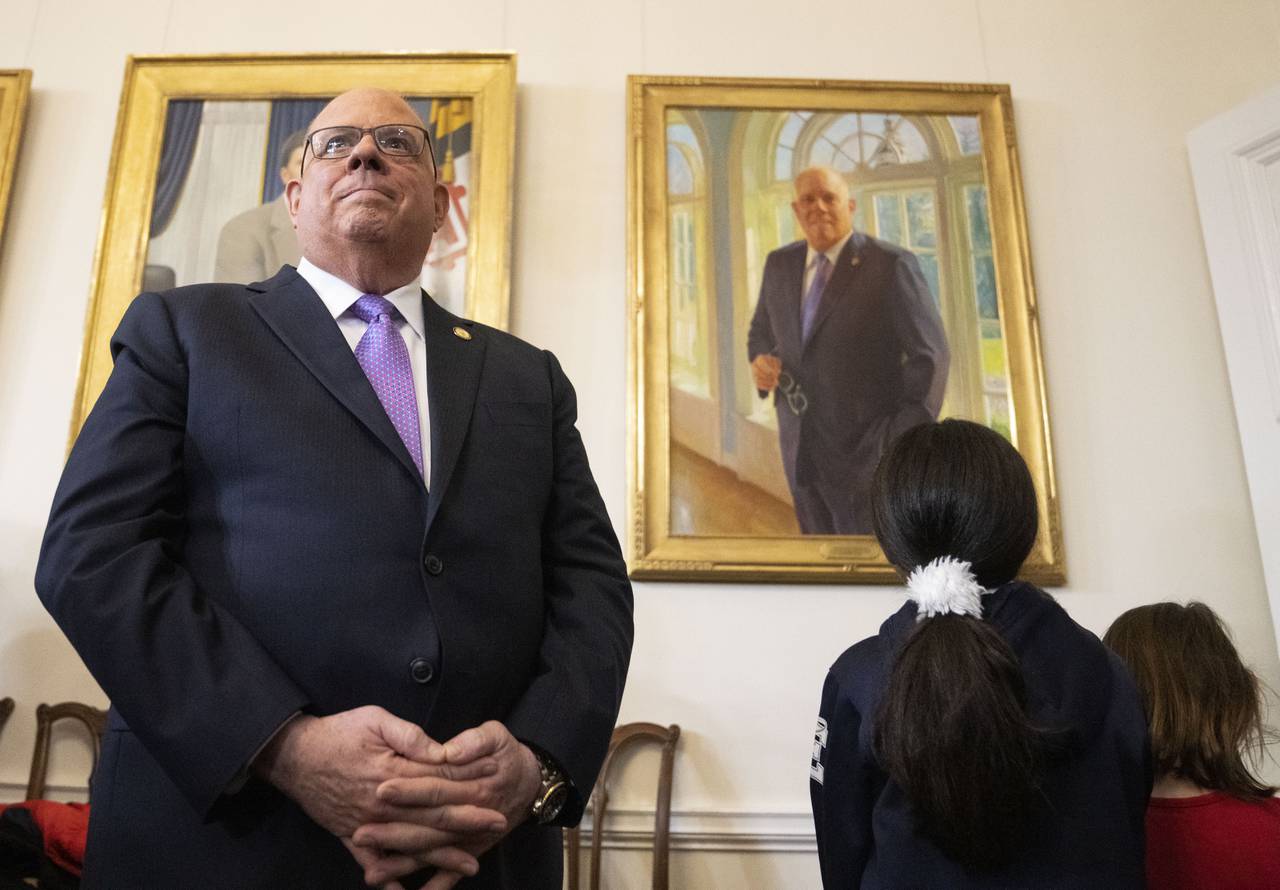 Maryland Gov. Larry Hogan after pulling down a cloth to reveal his portrait during the the hanging of his official portrait in the Governor's Reception Room, in Annapolis, Tuesday, January 10, 2023.
