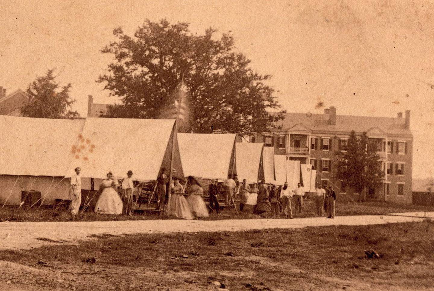 Nurses and other staff stand in the tent ward at U.S. General Hospital Division No. 1 on the grounds of the Naval Academy during the Civil War.
