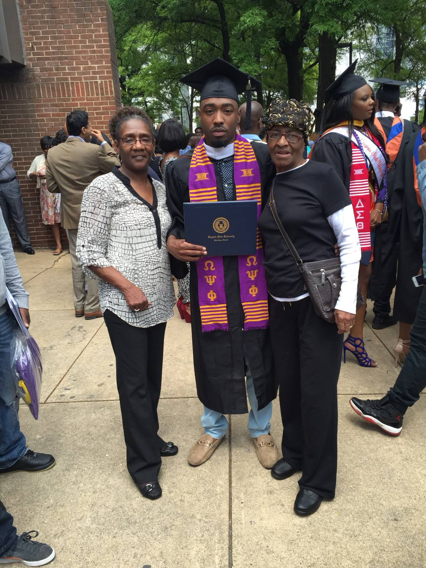 Kondwani Fidel with his grandmothers, Gail and Mary, at his college graduation in May 2015.