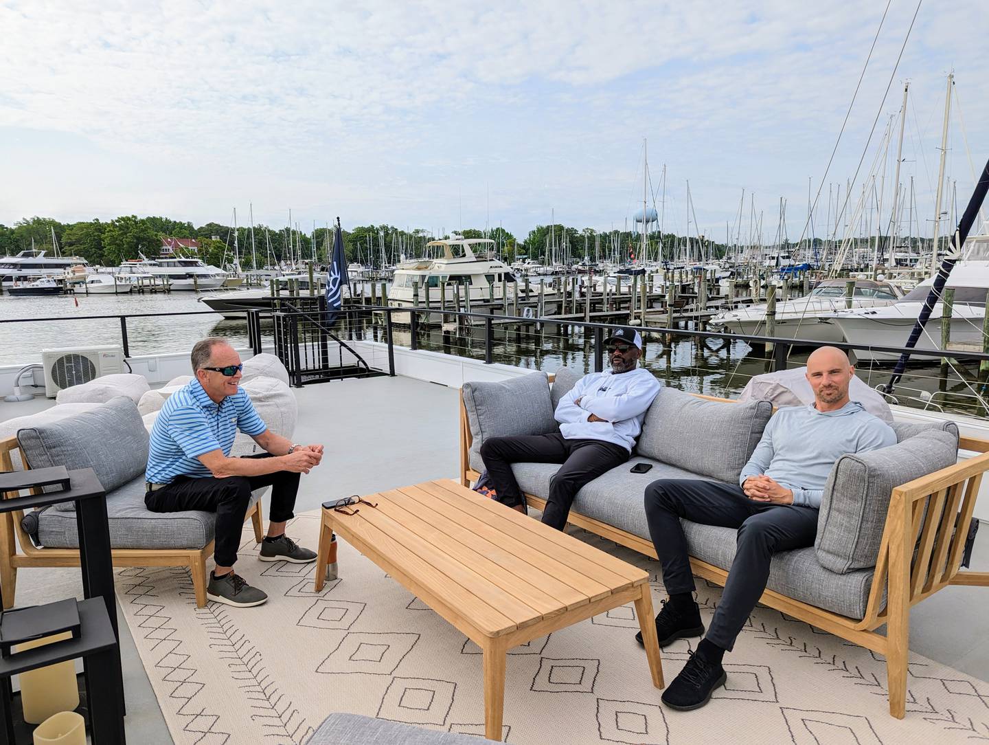 Partners in Flohom, from left, Jerry South, Marcellus Butler and Brian Meyer, talk about the launch of their hotel concept atop their first floating room in Annapolis.