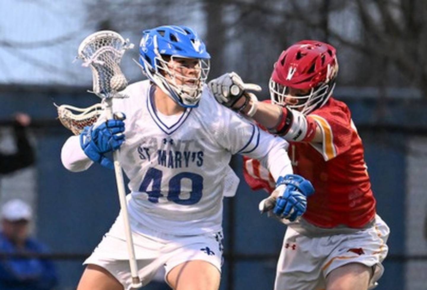 St. Mary's Gavin Burlace (40) works around a Calvert Hall defender during Friday night's MIAA A Conference opener. The University of Notre Dame recruit had 3 goals and 2 assists as the third-ranked Saints defeated No. 5 Calvert Hall, 13-3, at Pascal Field in Annapolis.