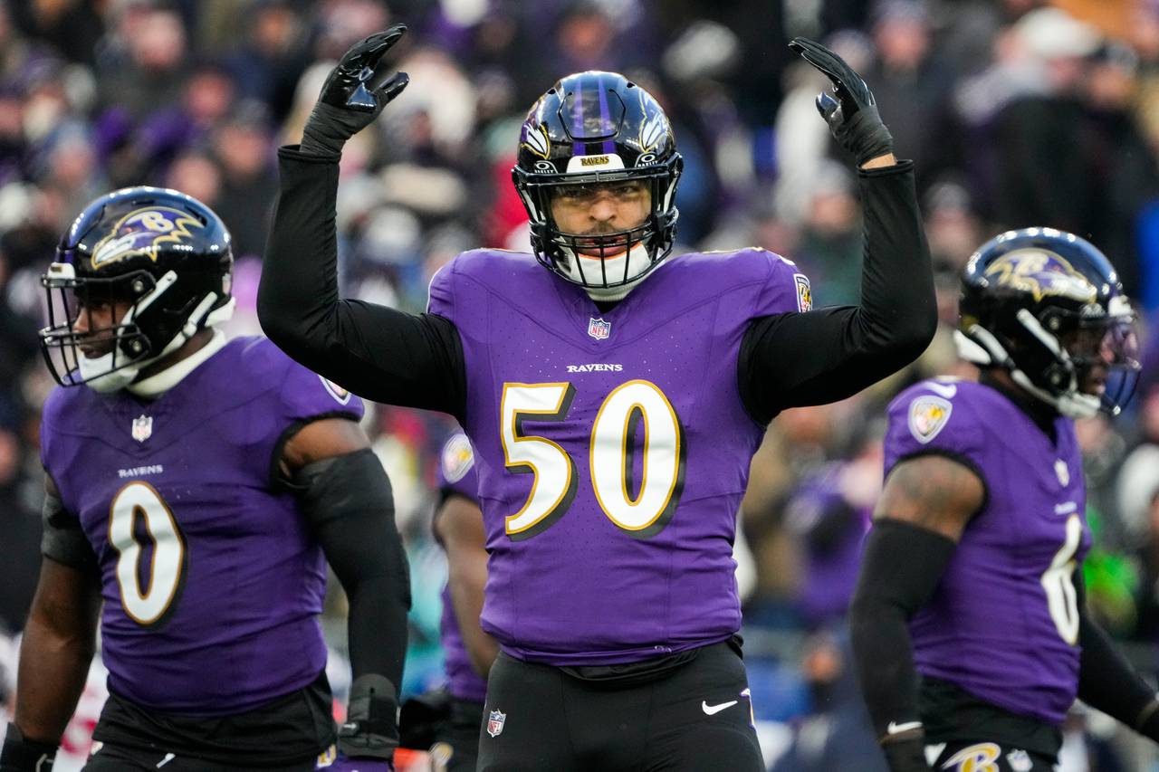 Baltimore Ravens linebacker Kyle Van Noy (50) hypes up the crowd during the first quarter against the Houston Texans at M&T Bank Stadium on Saturday, Jan. 20, 2024.