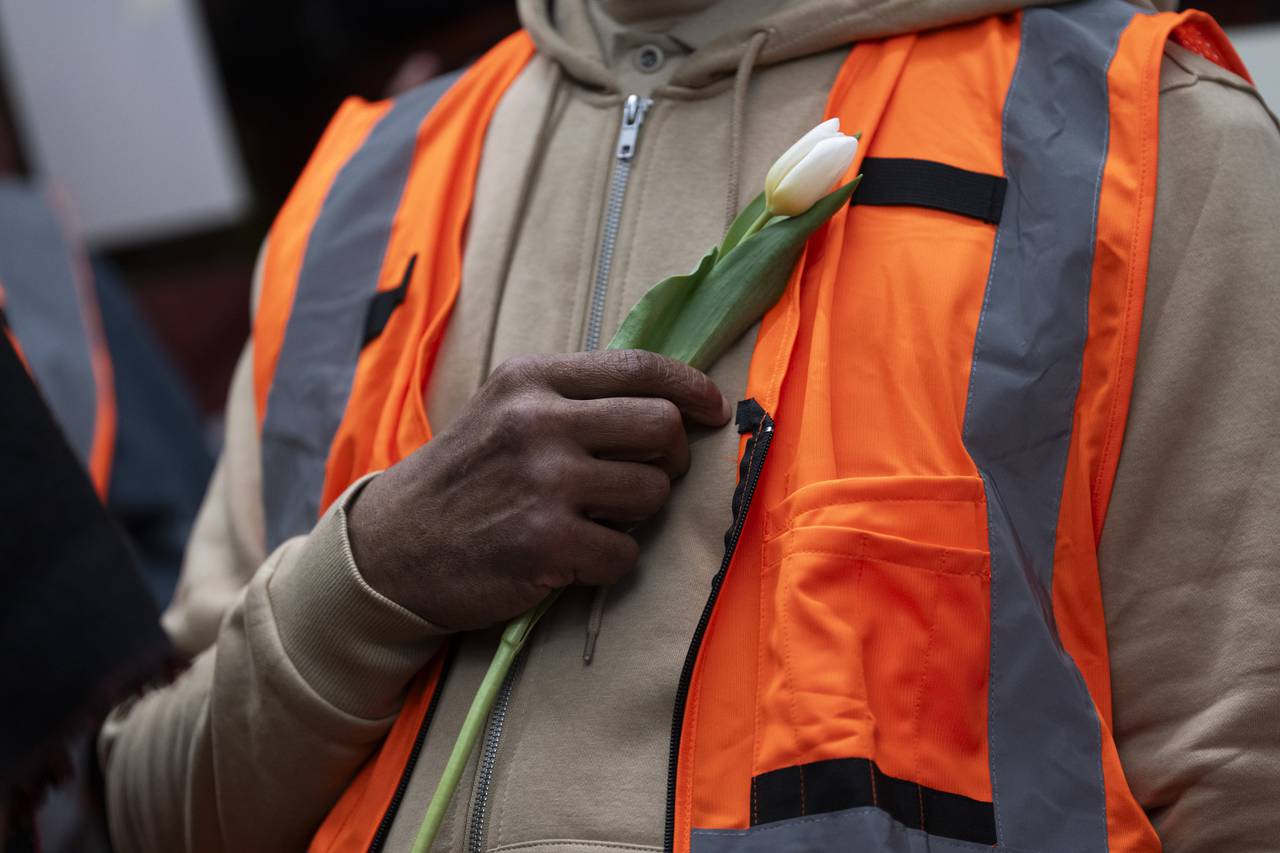 Construction workers honored the Key Bridge victims during a press conference on March 28, 2024 at CASA's Baltimore worker center. They held white flowers and raised their hands in solidarity.