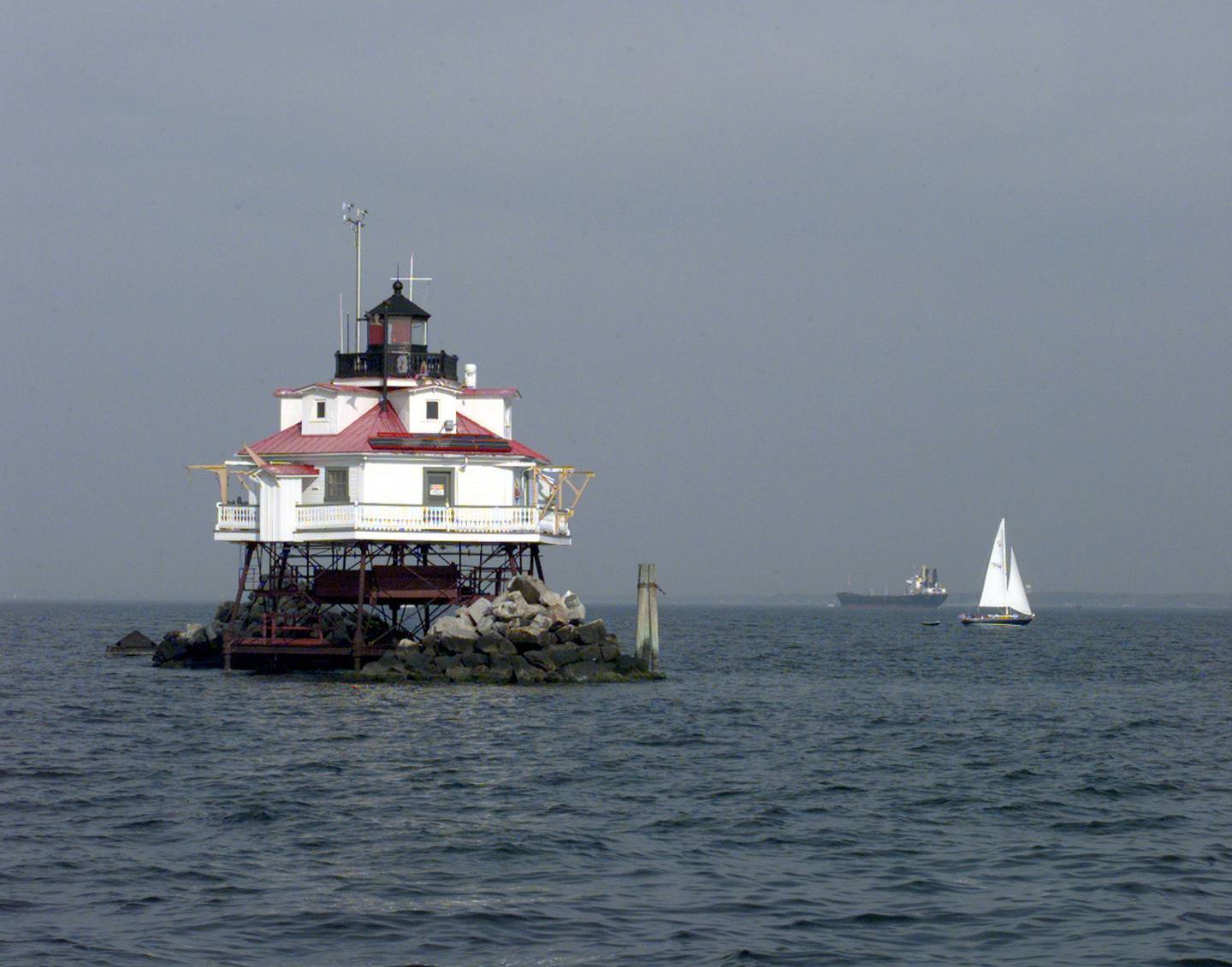 A sailboat cruises by the Thomas Point Shoal Light near Annapolis. The 140-year-old lighthouse is one of four sites proposed for a new national park on the Chesapeake Bay.