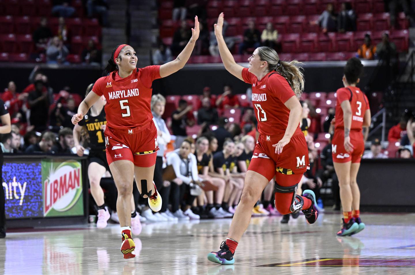 COLLEGE PARK, MARYLAND - FEBRUARY 21: Brinae Alexander #5 and Faith Masonius #13 of the Maryland Terrapins celebrate in the second quarter of the game against the Iowa Hawkeyes at Xfinity Center on February 21, 2023 in College Park, Maryland.