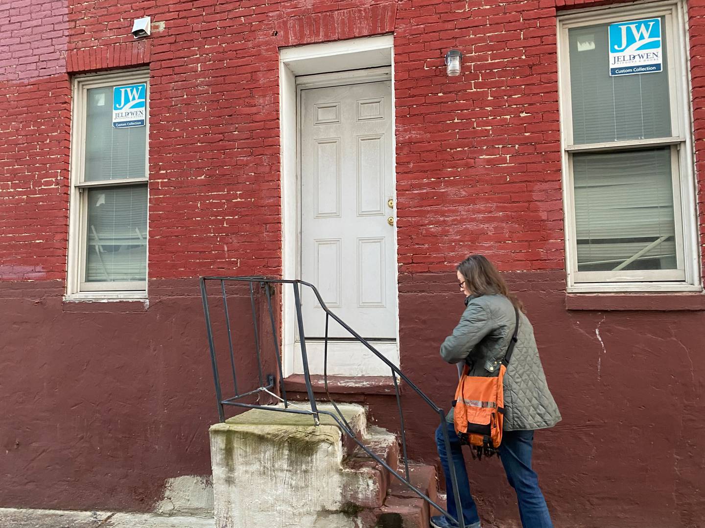 Abigail Breiseth, canvassing the neighborhood surrounding Steuart Hill before dark, approaches a door with flyers and a clipboard. Breiseth is a member of the coalition fighting to keep Steuart Hill open.