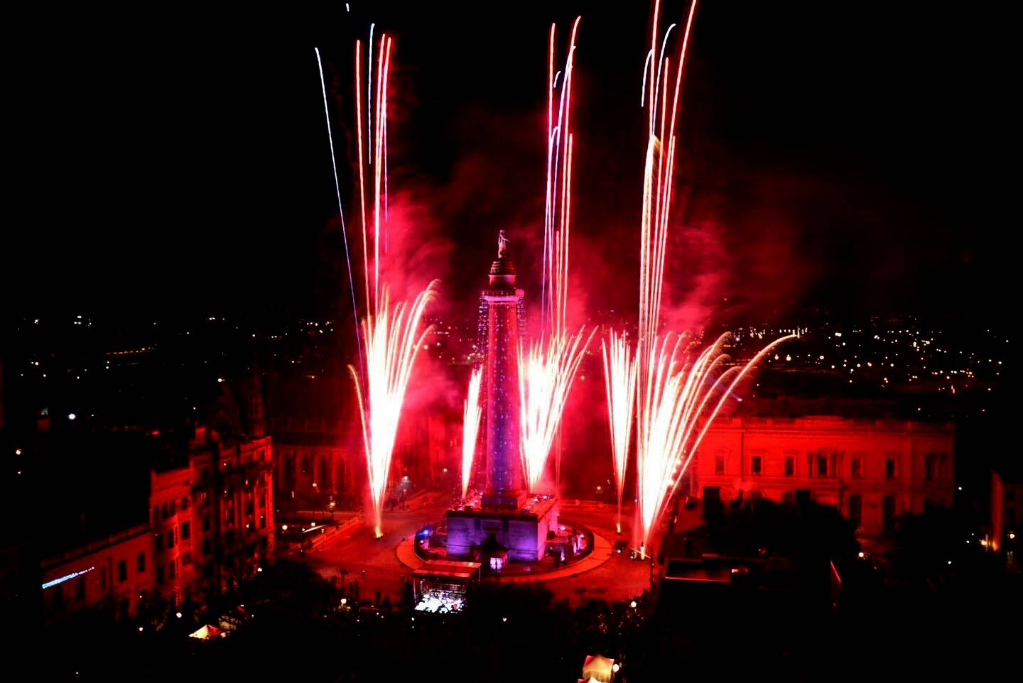 Fireworks ignite the sky at the 51st Monument Lighting in Mount Vernon Thursday night, kicking off the start of December’s holiday season, seen from Topside in hotel Revival in Baltimore.