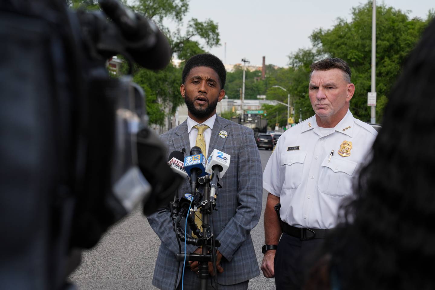 Deputy Commissioner Richard Worley, right, stands next to Baltimore Mayor Brandon Scott as the mayor speaks at a press conference on May 11, 2023.