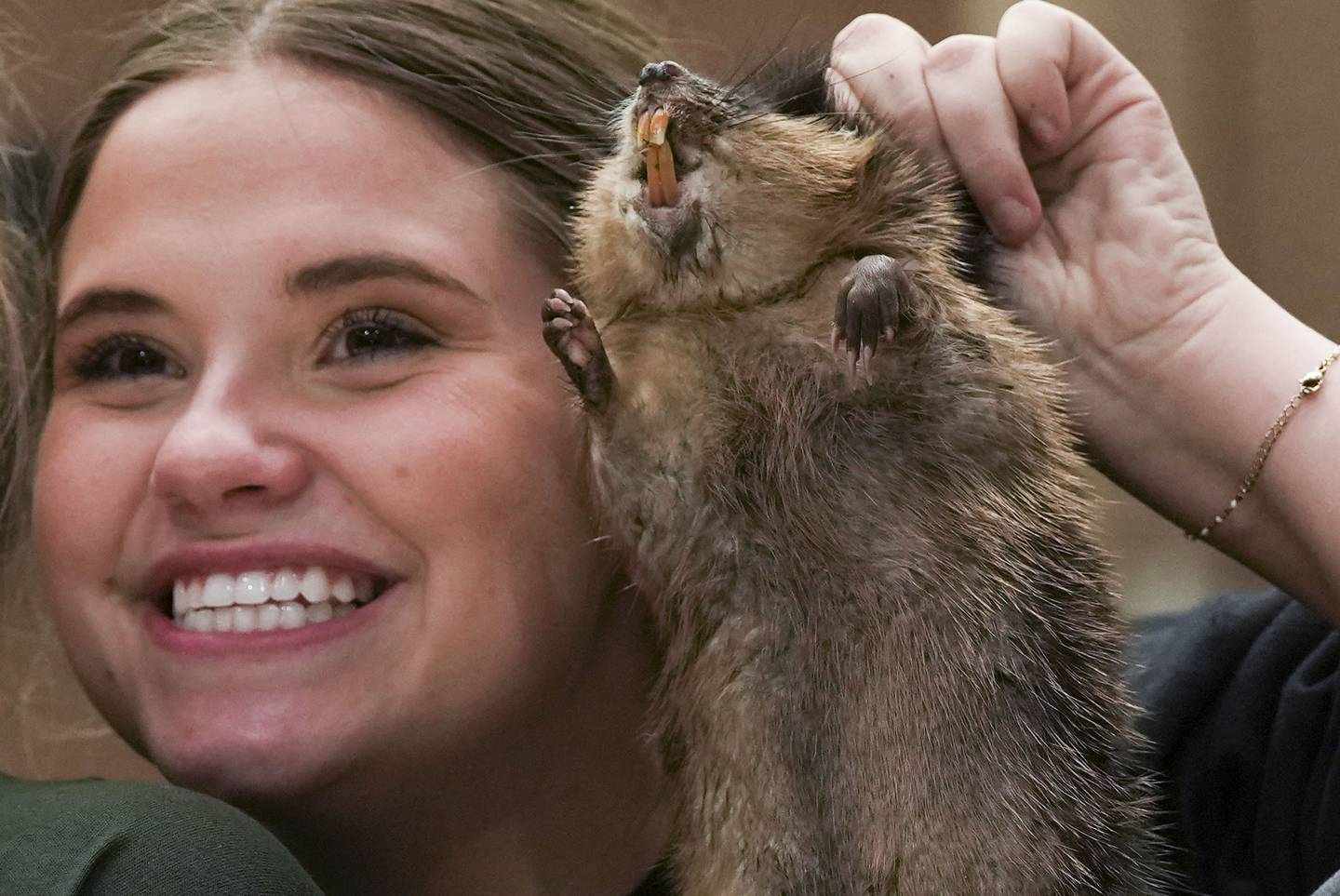 Cesilee Oliver, 18, Miss Cameron Parrish 2022 from Cameron Parrish, LA holds up a fresh muskrat before skinning it at The National Outdoors Show in Dorchester County, MD on February 25, 2023.