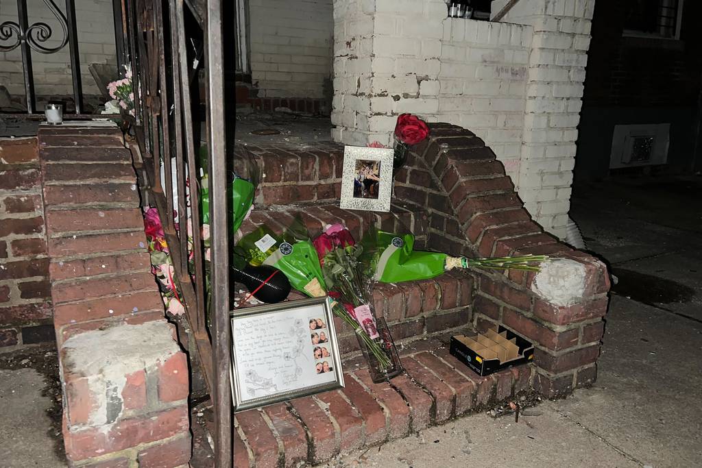 A memorial is set up for Brittany Wolf on the steps of a vacant home in East Baltimore where she died of smoke inhalation.