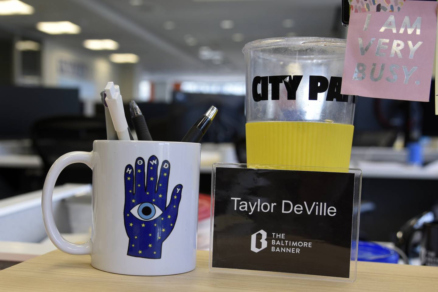 A "Howdy" mug from Sideshow at the American Visionary Art Museum adorns Baltimore Banner reporter Taylor DeVille's desk.