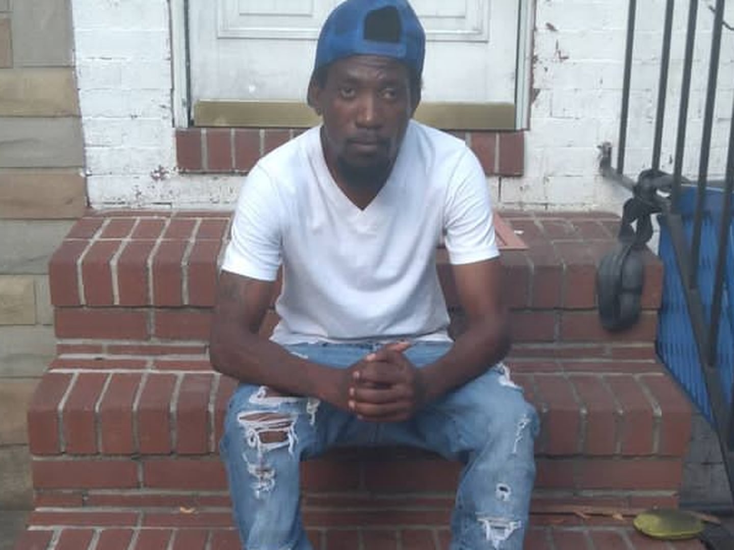 Javarick Gantt, 34, sits on a stoop and poses for a photograph at an unknown location in Baltimore. Gantt was murdered by an unknown assailant at a state-run jail in the city earlier this month.