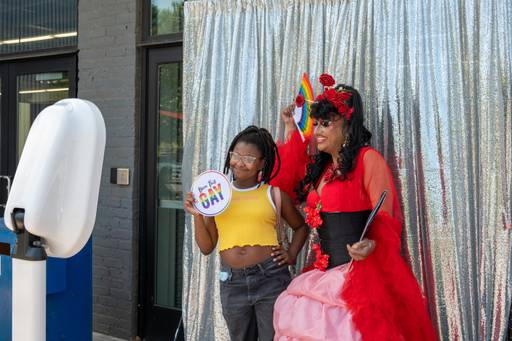 Jay, 13, poses for a photo with Vee Vee after her Drag Story Hour performance at Open Works. The photo booth is run by Tia G., owner of Charm City Soiree.