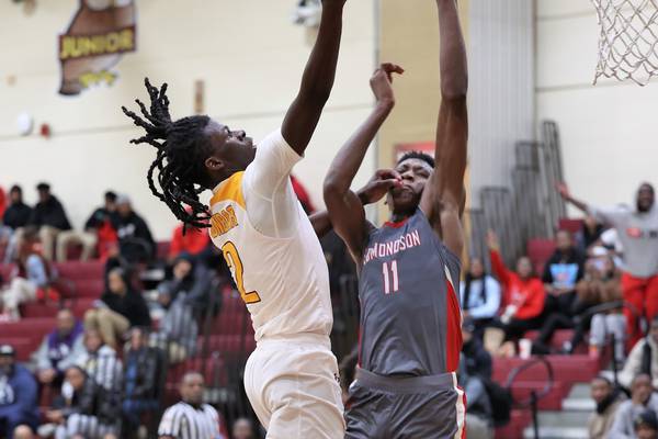 Dunbar's Otis Toney heads up to the basket as Edmondson's Marcus Jackson defends during Thursday's Baltimore City boys basketball contest. Toney finished with 24 points as the Poets built an early lead and held on for a 69-60 win over No. 6 Edmondson in East Baltimore.