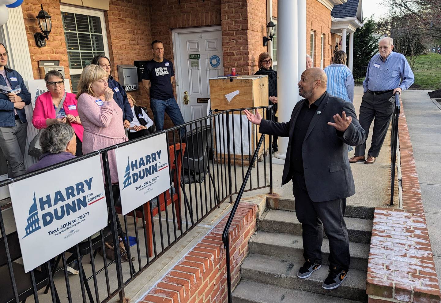 Harry Dunn, a retired U.S. Capitol Police officer, talks with potential voters who turned out on March 12, 2024 for the opening of his campaign headquarters in Ellicott City. Dunn is one of more than 20 candidates for Congress in the 3rd District.