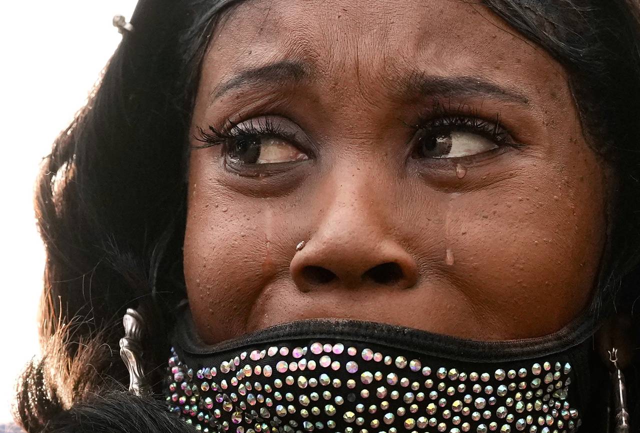 Tawanda Jones, sister of Tyrone West, cries as she speaks out on police brutality at a rally for Tyre Nichols on the corner of North Avenue and North Charles Street on January 28, 2023.