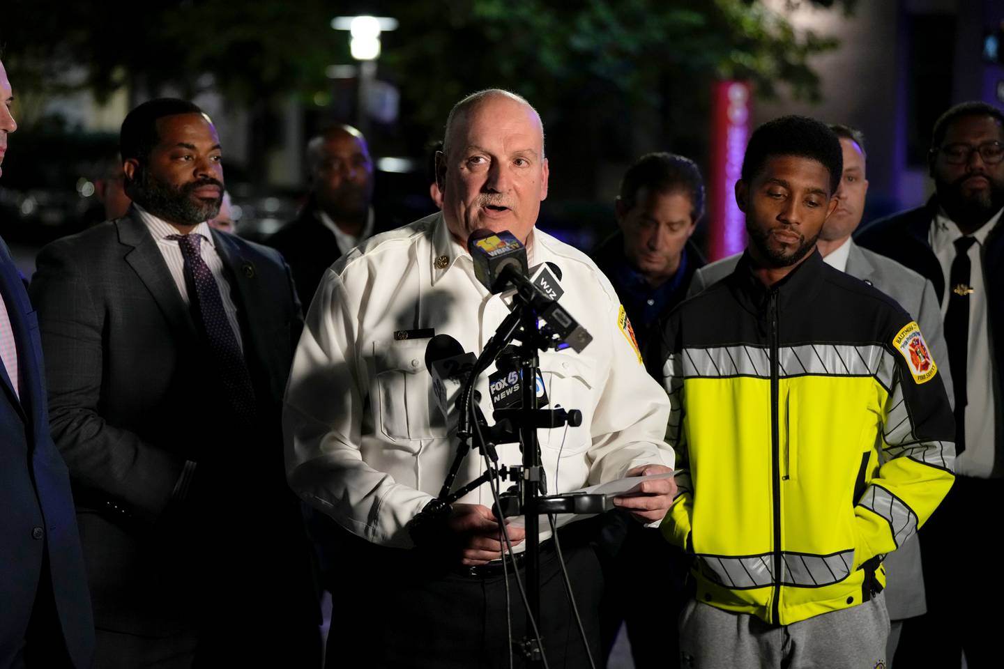 Fire Chief James Wallace makes a statement to the press with councilmen Nick Mosby (left) and Mayor Brandon Scott (right).