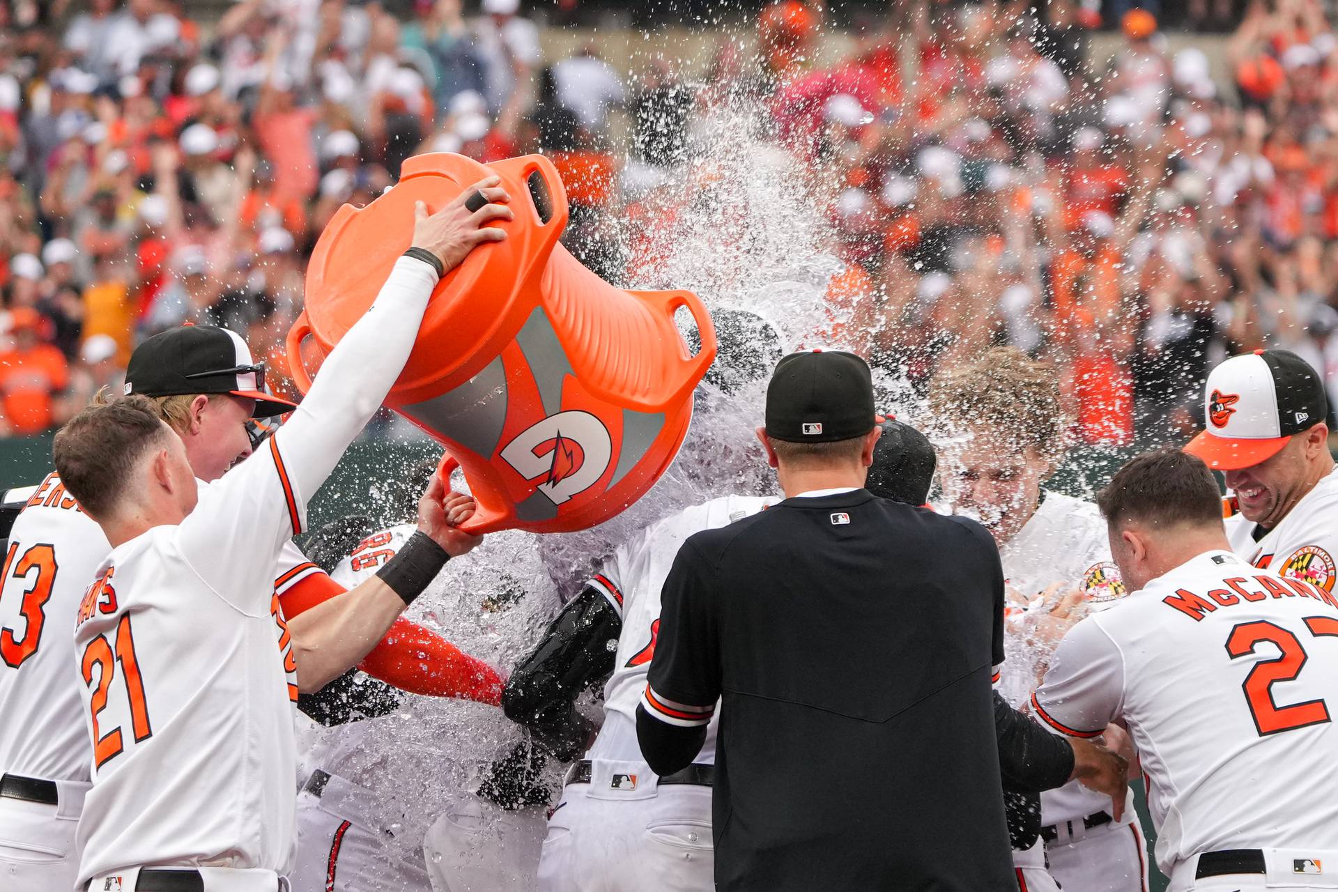 Baltimore Orioles left fielder Austin Hays (21) dumps gatorade on center fielder Cedric Mullins after he hit a sacrifice fly in the eleventh inning to win the game against the Tampa Bay Rays on Sunday, September 17, 2023. The Baltimore Orioles clinched a spot in the postseason for the first time since 2016.