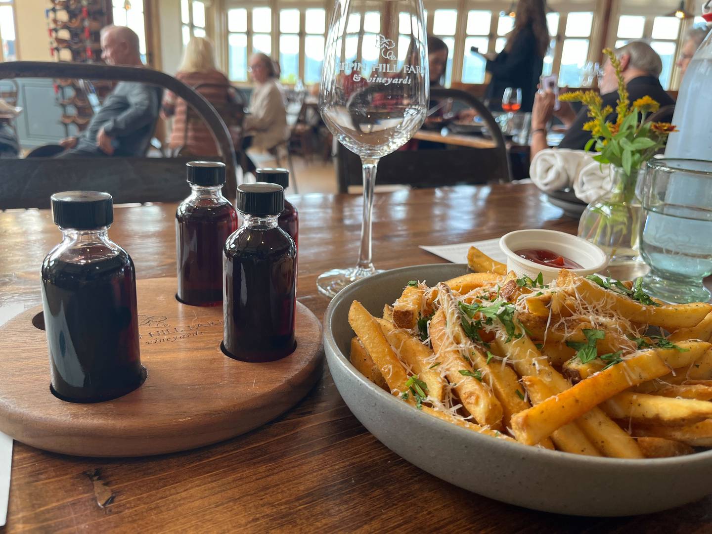 A red wine tasting flight and parmesan fries with herbs are just a few of the items on the menu at Pippin Hill Farm and Vineyards.