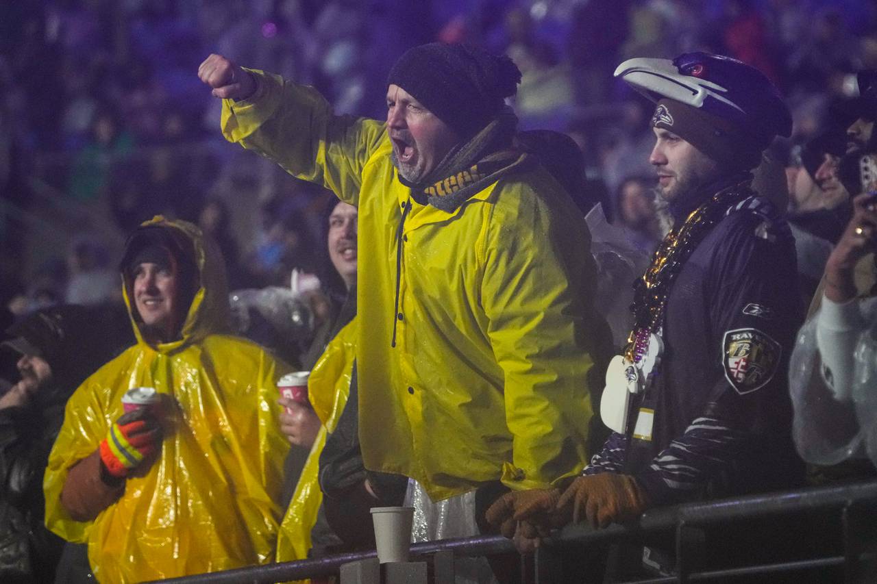 A Pittsburgh Steelers fan cheers next to a Baltimore Ravens fan during the game at M&T Bank Stadium on Saturday, Jan. 6, 2024.