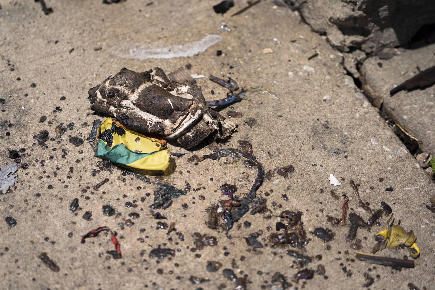 Charred pieces of the pride flag lay near row homes on the 300 block of E. 31st St. The fire was presumed started by the burning of a pride flag.