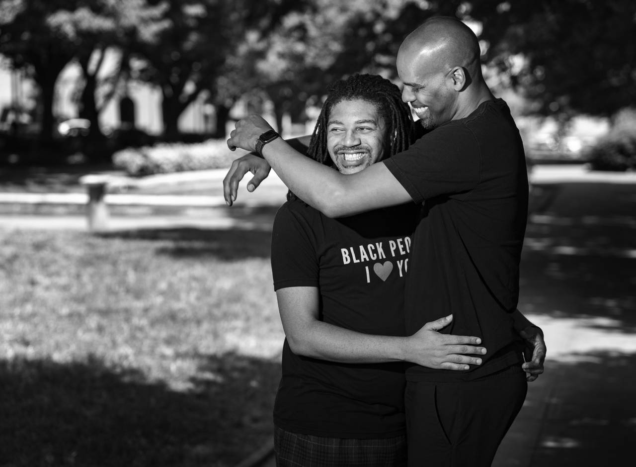 Blair and Brandon Dottin-Haley, husbands, poses together for a portrait around Mount Vernon, in Baltimore, Tuesday, May 30, 2023.