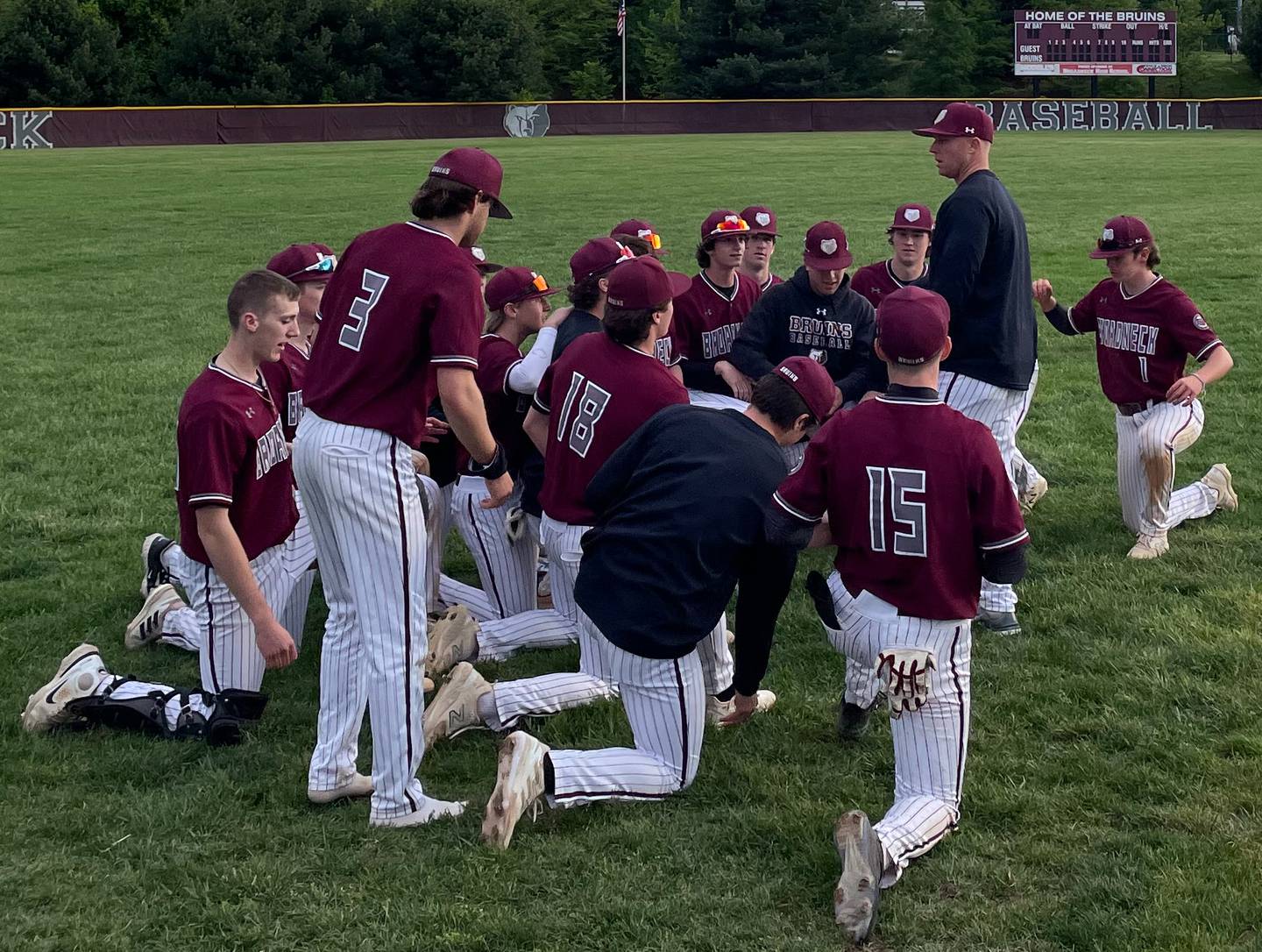 Broadneck baseball coach Matt Skrenchuk (standing) talks to his team after Monday's victory over Glen Burnie. The No. 3 Bruins remained in first in the Anne Arundel County standings with a 8-1 victory over Glen Burnie in Cape St. Claire.