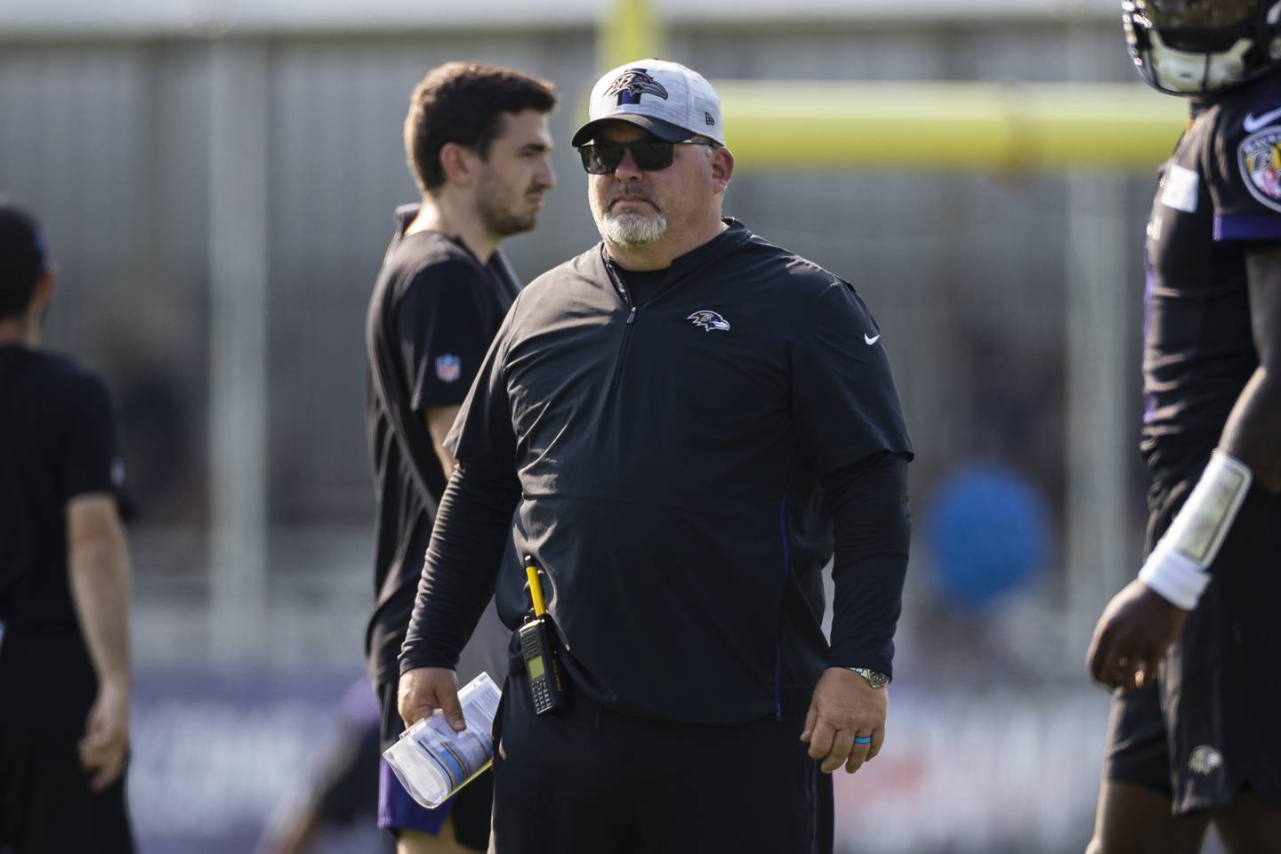 OWINGS MILLS, MD - JULY 28: Offensive coordinator Greg Roman of the Baltimore Ravens watches play during training camp at Under Armour Performance Center Baltimore Ravens on July 28, 2021 in Owings Mills, Maryland.