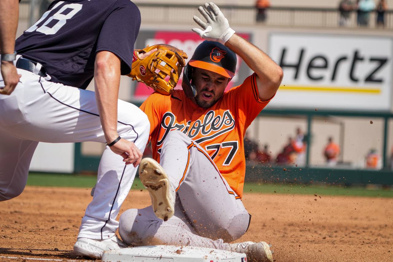 Terrin Vavra (77) slides to third base at Publix Field at Joker Marchant Stadium after tripling during the fourth inning of a game against the Detroit Tigers on 3/2/23. The Baltimore Orioles traveled to Lakeland to play the Tigers in the Florida Grapefruit League.