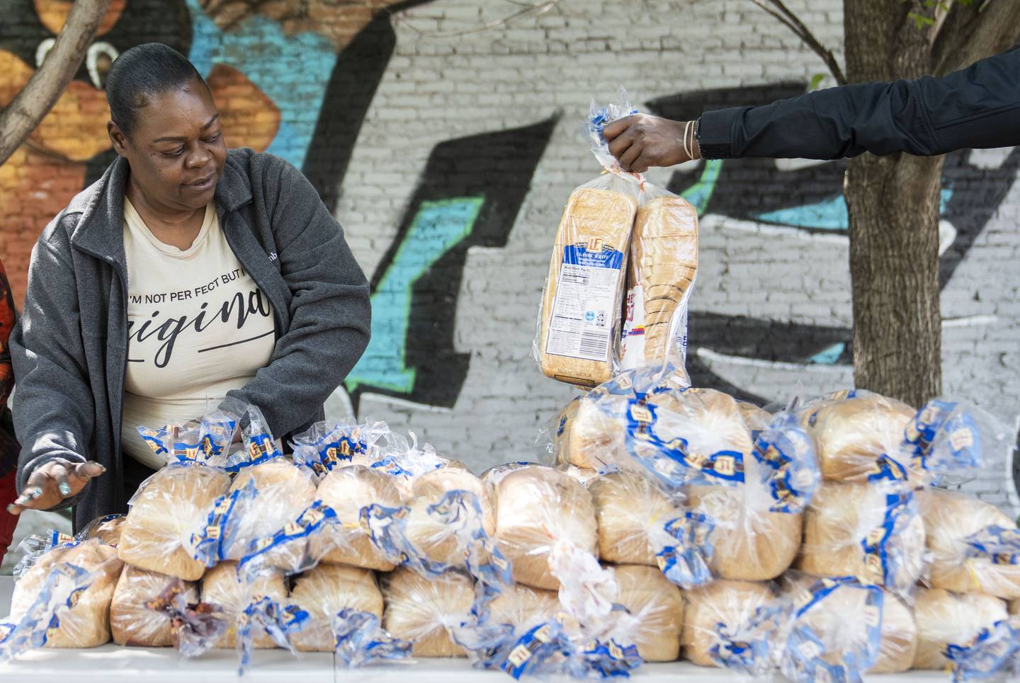 Sonya Williams organizes bread for Farm to Stoop at the YNot Lot in Baltimore, Wednesday, May 10, 2023.