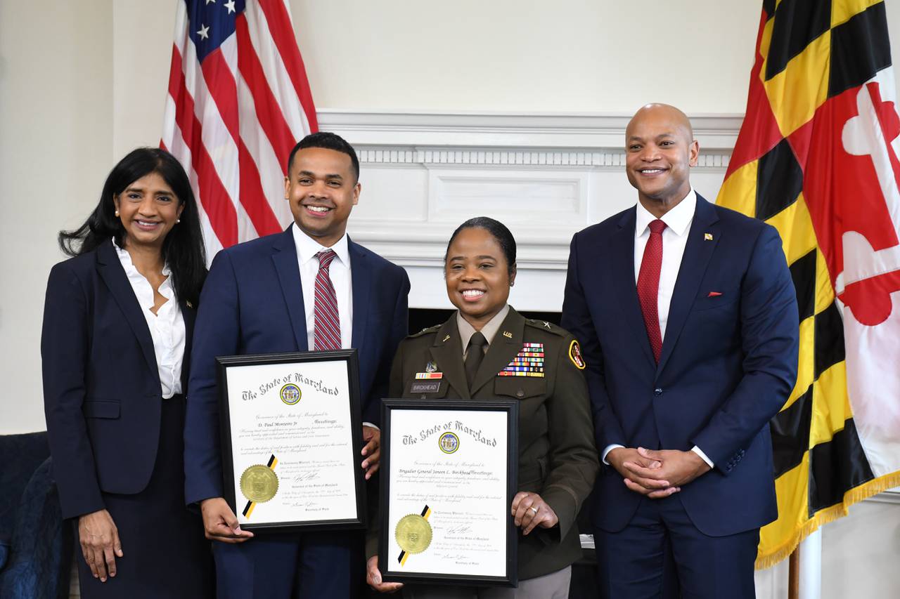 Paul Monteiro, the state secretary of service and civic innovation, and Brig. Gen. Janeen L. Birckhead, state adjutant general, pose for pictures with Lt. Gov. Aruna Miller and Gov. Wes Moore after being sworn into office at the State House in Annapolis on Thursday, April 27, 2023.