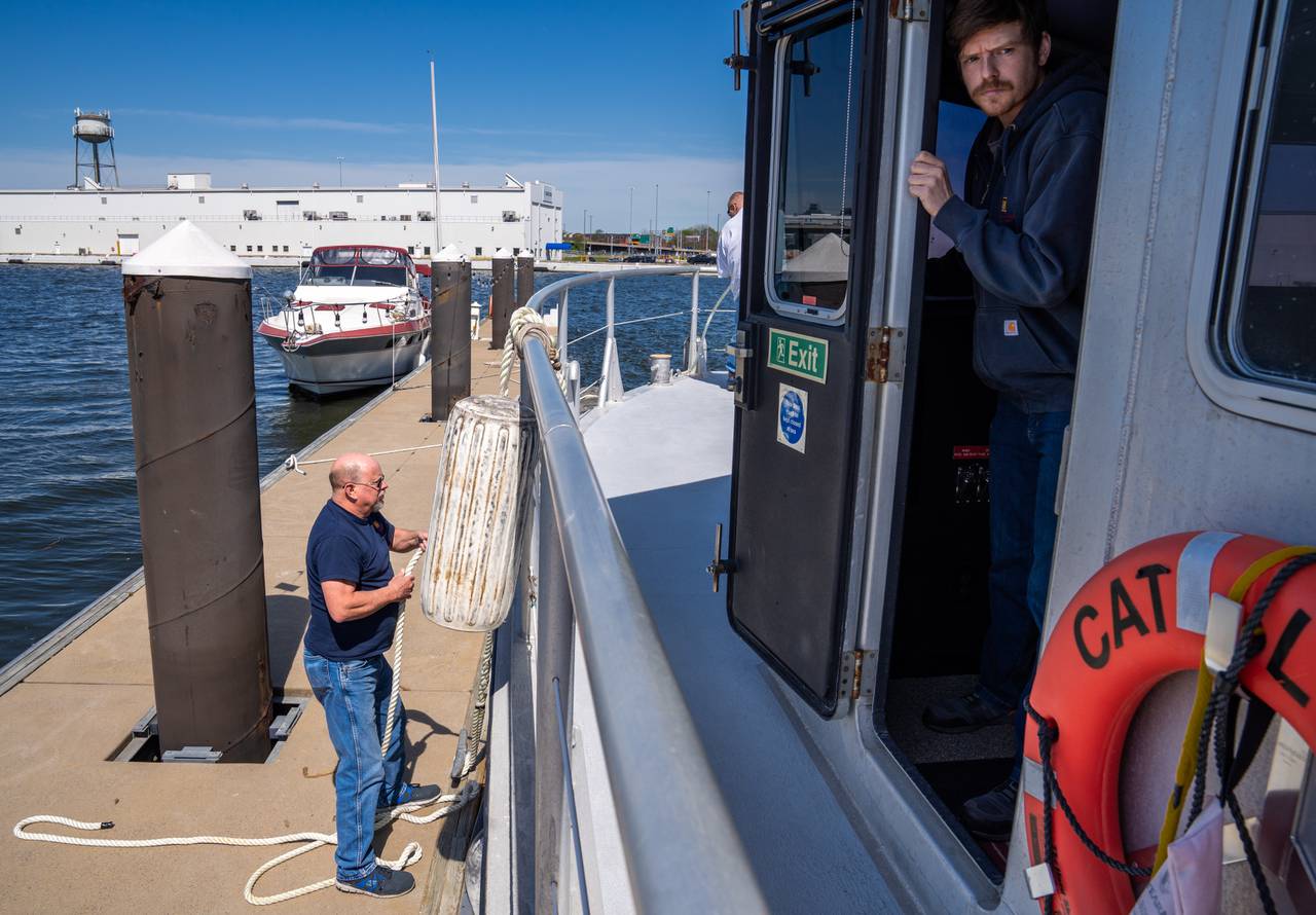 Jeff Peacock, left, secures the Catlett as Jacob Tuer makes sure the boat is pulled up evenly to the pier on Tuesday, April 16, 2024.