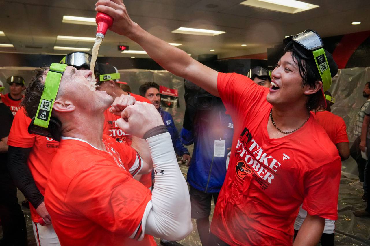 Baltimore Orioles relief pitcher Shintaro Fujinami pours a beer into left fielder Austin Hays’ mouth in the clubhouse following the team’s playoff-clinching win against the Tampa Bay Rays on Sunday, September 17, 2023. The Orioles earned a spot in the playoffs for the first time since 2016.