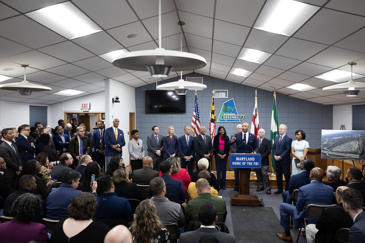 Maryland state and local officials stand beside Maryland Governor Wes Moore as he speaks during a press conference on the Selection of Greenbelt for the FBI's New Headquarters in Greenbelt, Maryland, on Friday, November 10, 2023.