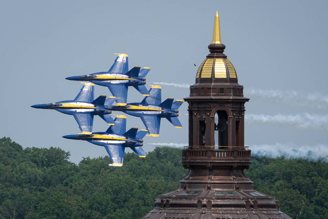 The U.S. Navy Blue Angels fly past the Naval Academy Chapel dome on May 24, 2023, as seen from the top of the State House. The show is part of a series of events during the Naval Academy’s Commissioning Week, all leading up to the graduation ceremony on Friday morning.