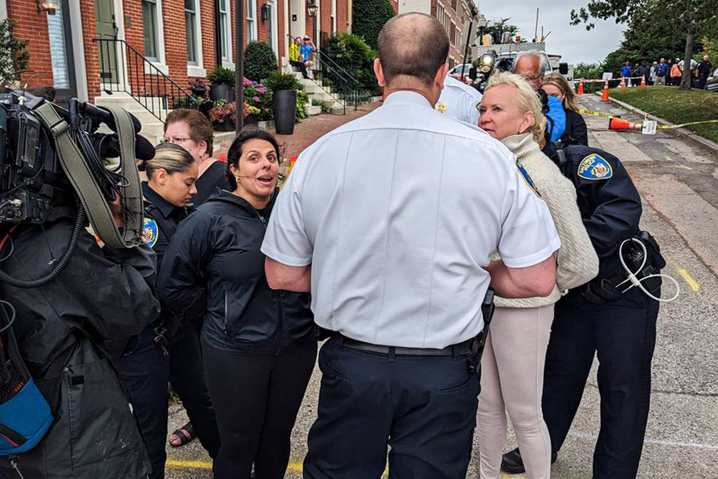 Claudia Towles, just left of center, is arrested by a Baltimore Police officer during a protest on Warren Avenue next to Federal Hill on Thursday, June 22.