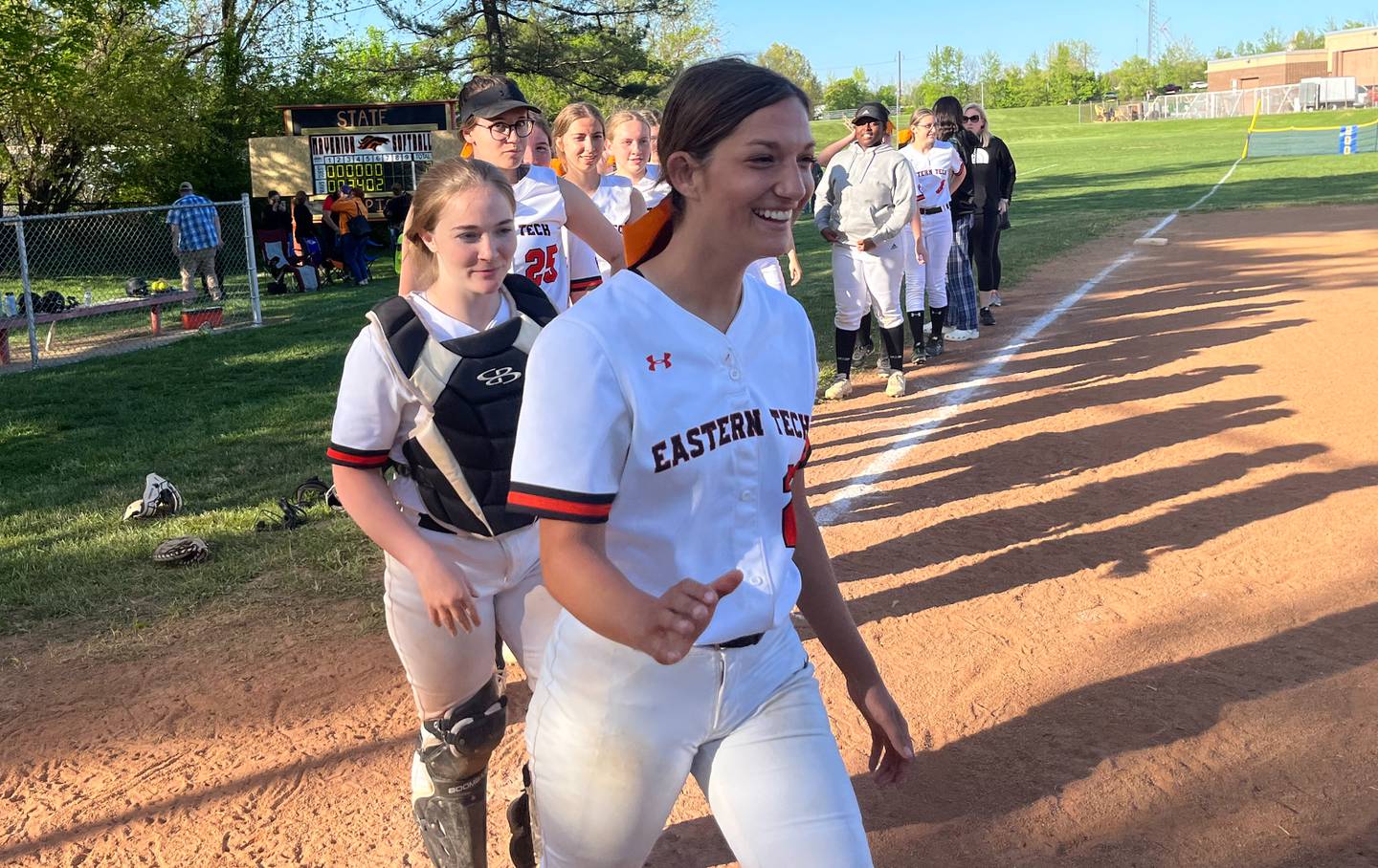 Malorie Gogel (front) leads Eastern Tech's line for postgame handshakes after Tuesday's victory over Catonsville. The No. 13 Mavericks improved to 8-1 with a 9-2 decision over the Comets in Essex.