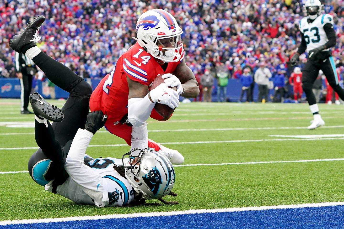 Stefon Diggs #14 of the Buffalo Bills catches an eleven-yard pass over Stephon Gilmore #9 of the Carolina Panthers and runs in for a touchdown in the second quarter of the game at Highmark Stadium on December 19, 2021 in Orchard Park, New York.